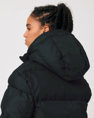 Person wearing a black puffer jacket on a white background